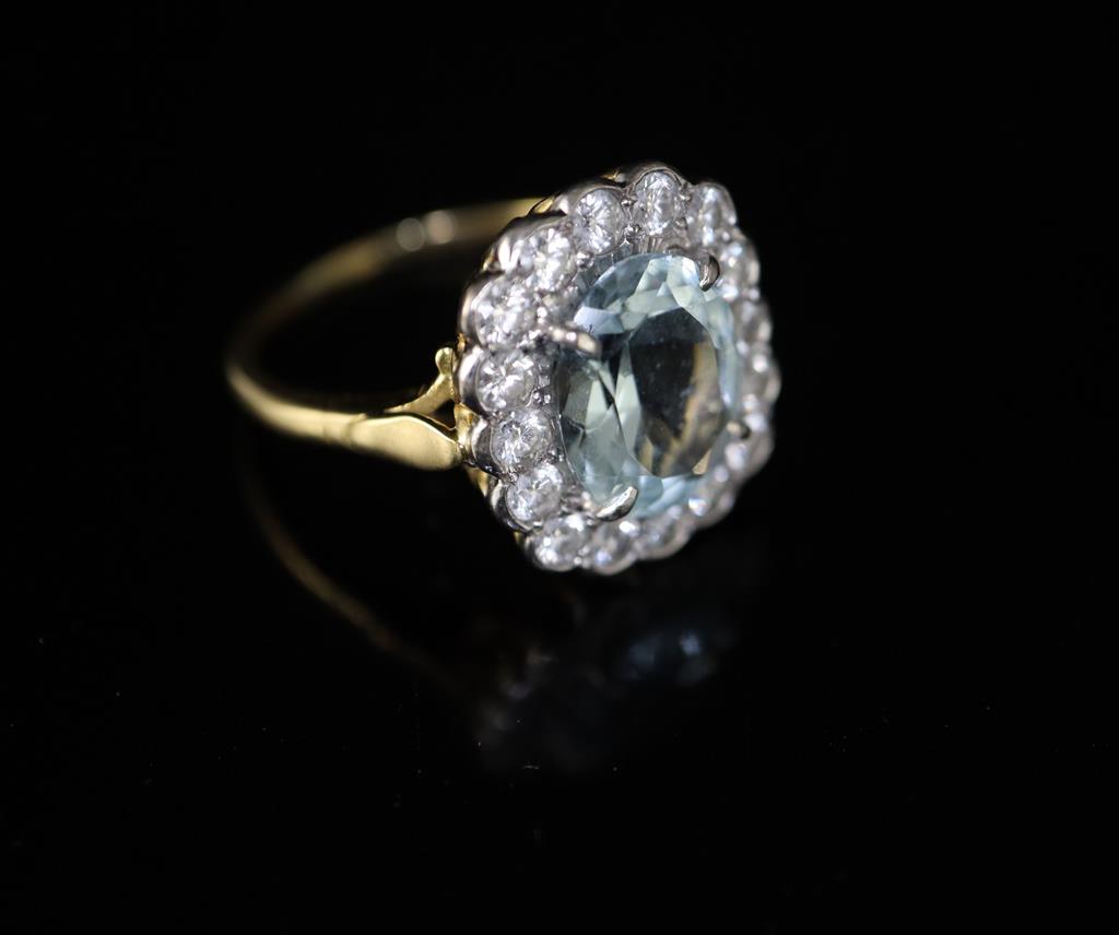 A modern 18ct gold, aquamarine and diamond cluster ring,